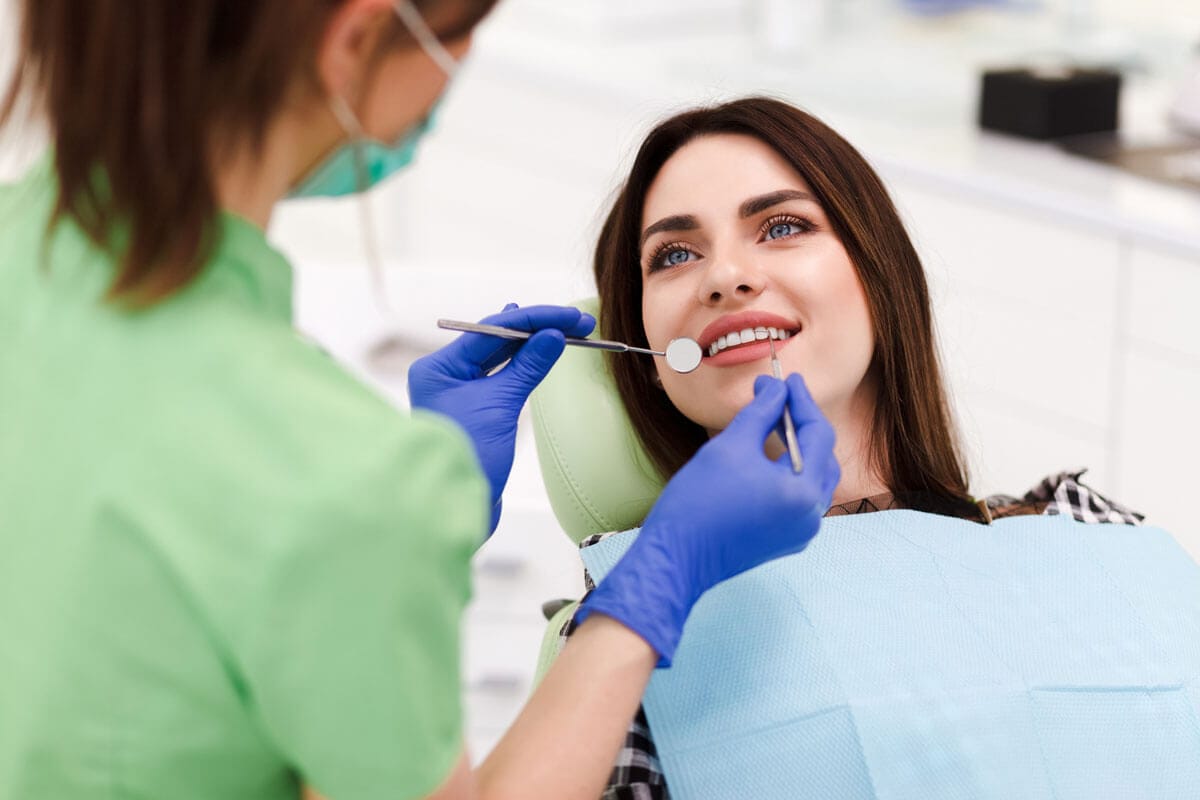 Dentist examining a patient's teeth at Biolume Dental Care, Sector 19B, Vashi
